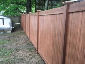 Solid wooden fence along the perimeter of a backyard