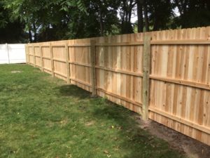 New wooden fence surrounding a backyard