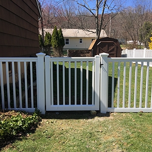 Attractive white vinyl fence with gate on a residential property
